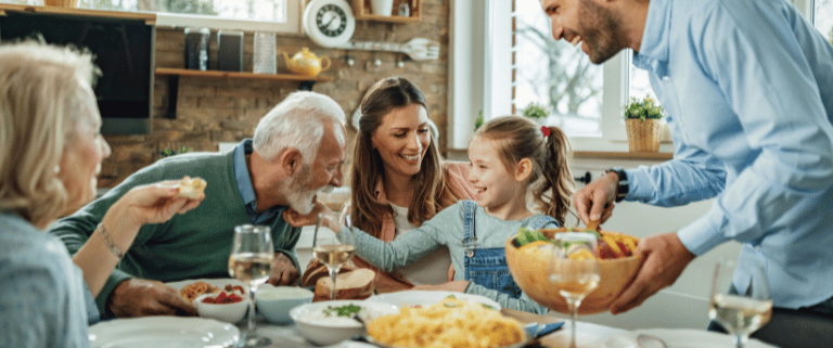 Family gathering around the table during the holidays laughing