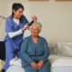 senior women getting her hair brushed by home health aide.